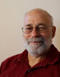 Headshot of Jerry Koch-Gonzalez, grinning