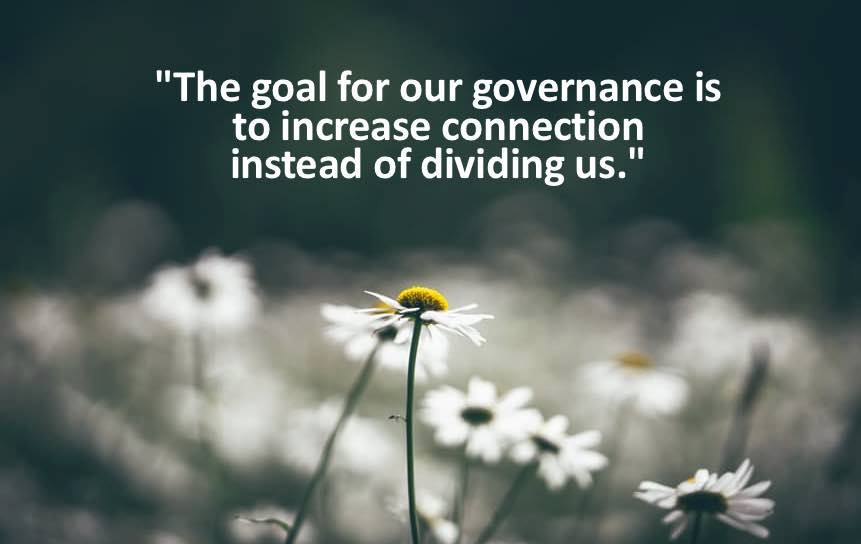 Daises in the background, text reads "The goal for our governance is to increase connection instead of dividing us."