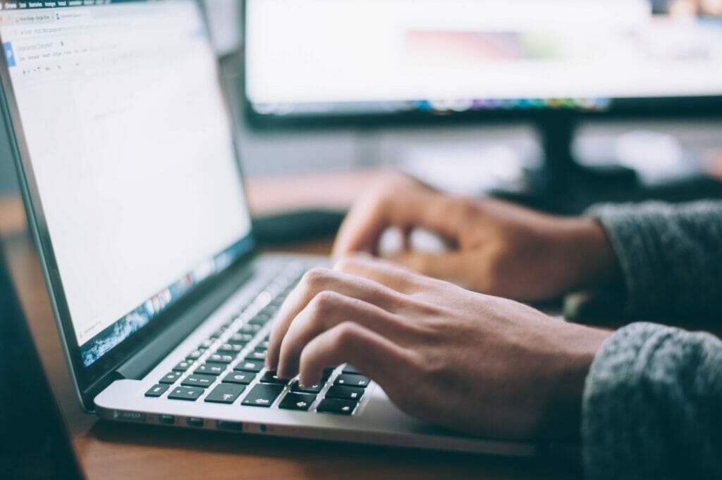 A pair of hands typing on an open laptop keyboard.
Photo by Glenn Carstens-Peters on Unsplash