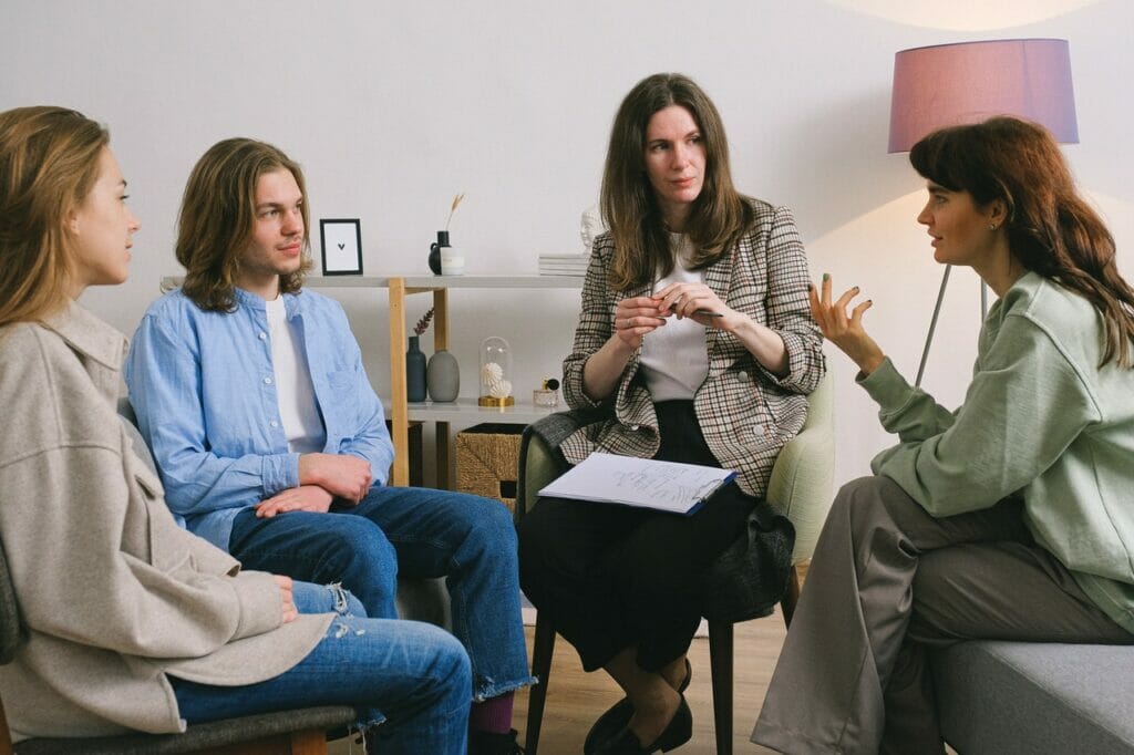 Picture of a small group of people having a meeting to give feedback.