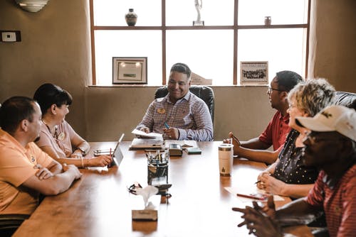 People sitting around a wooden table.