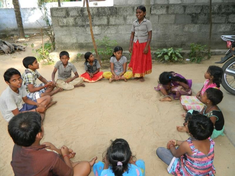 Girl speaking at a children's parliament neighborhood meeting