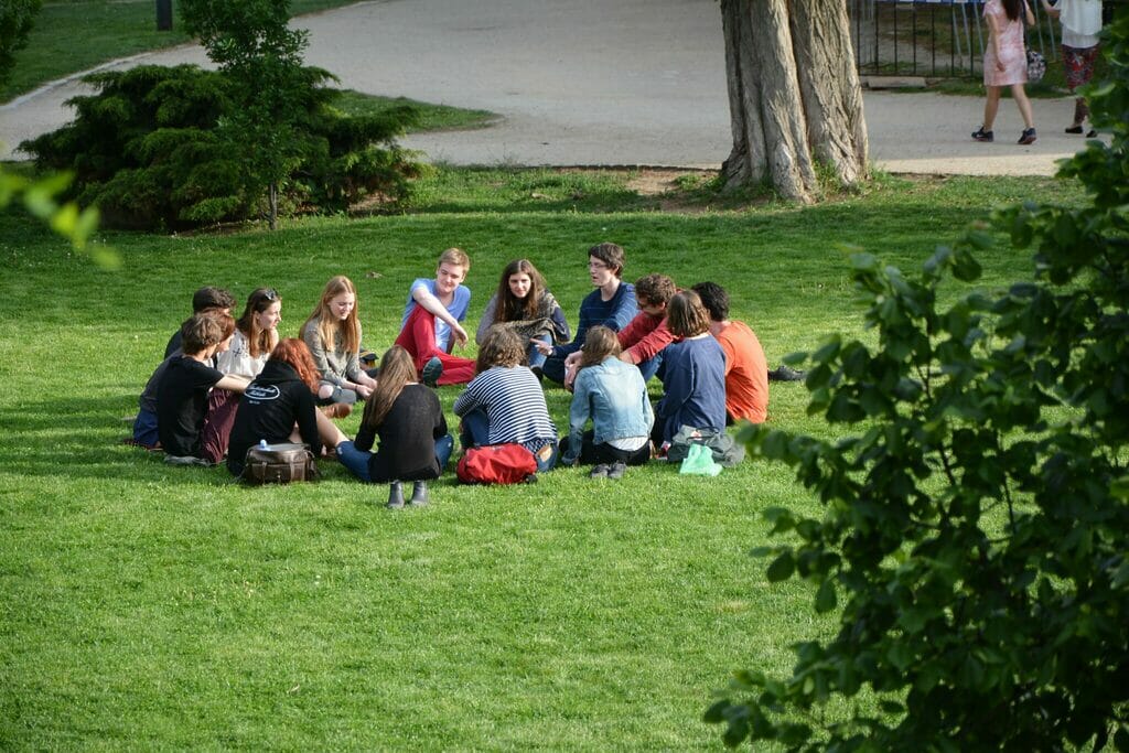 Group of people in circle in the park. They could live the myth of natural flow. - Sociocracy For All